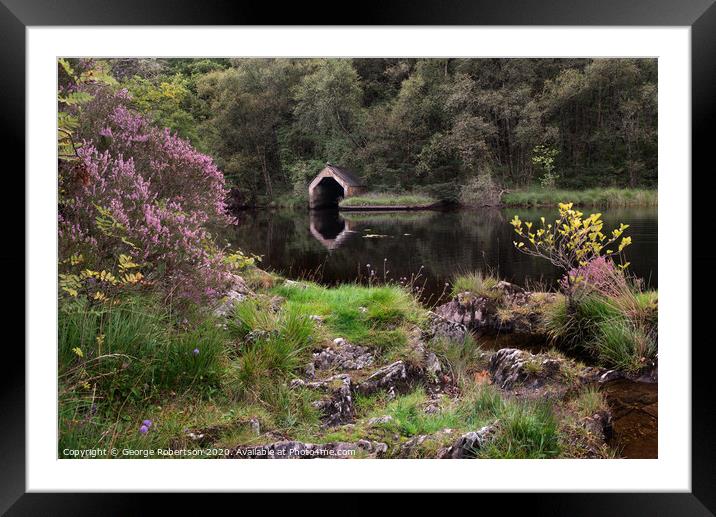 Purple heather and reflections of an Old Boathouse Framed Mounted Print by George Robertson
