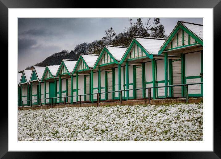 Langland Bay Beach Huts in the snow Framed Mounted Print by Dan Santillo