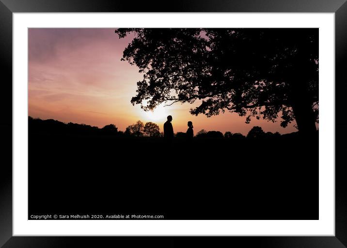 Two people standing under a tree in front of a sunset Framed Mounted Print by Sara Melhuish