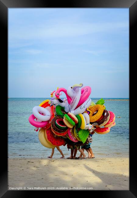 People hiding behind beach toys Framed Print by Sara Melhuish