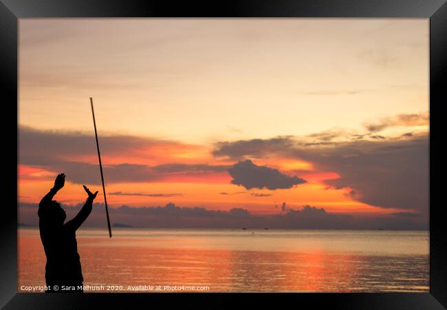Man juggling at sunset in Thailand Framed Print by Sara Melhuish