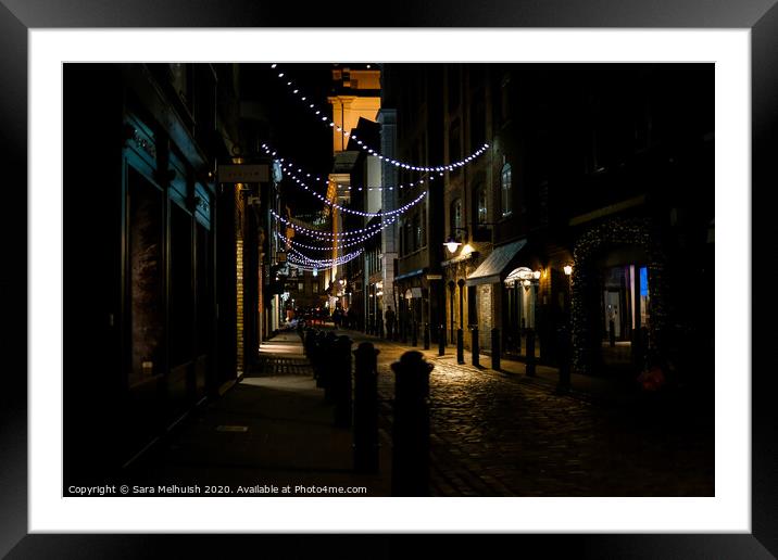 Cobblestones and Christmas lights Framed Mounted Print by Sara Melhuish