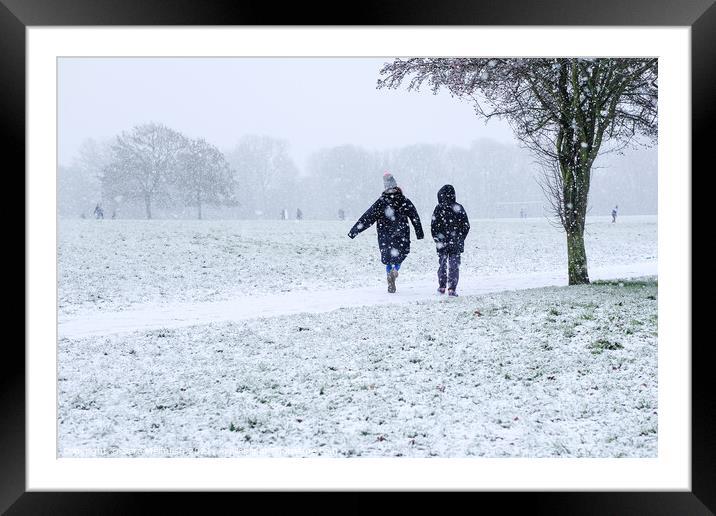 A stroll with a friend in the snow Framed Mounted Print by Sara Melhuish