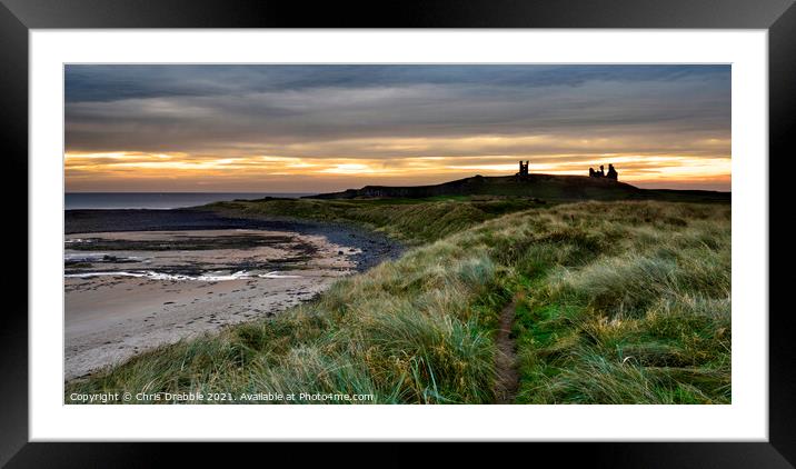 First light at Dunstanburgh Castle Framed Mounted Print by Chris Drabble