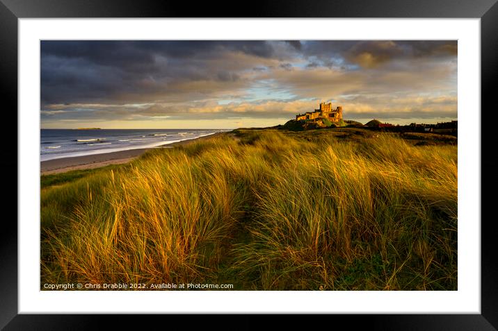 Bamburgh Castle at sunset Framed Mounted Print by Chris Drabble