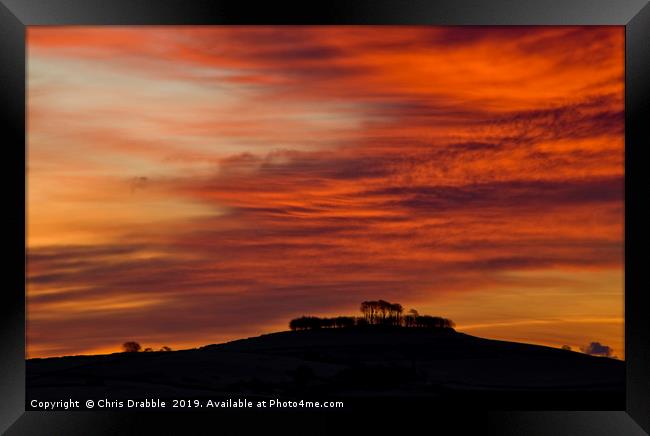 Minninglow with light from the rising sun Framed Print by Chris Drabble