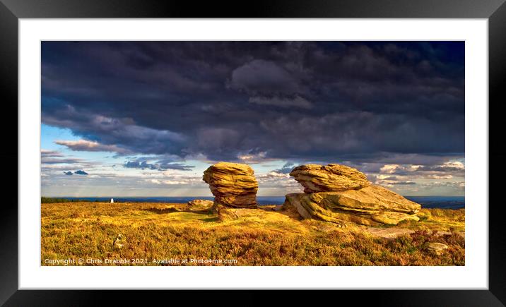 The Ox Stones caught in storm light Framed Mounted Print by Chris Drabble