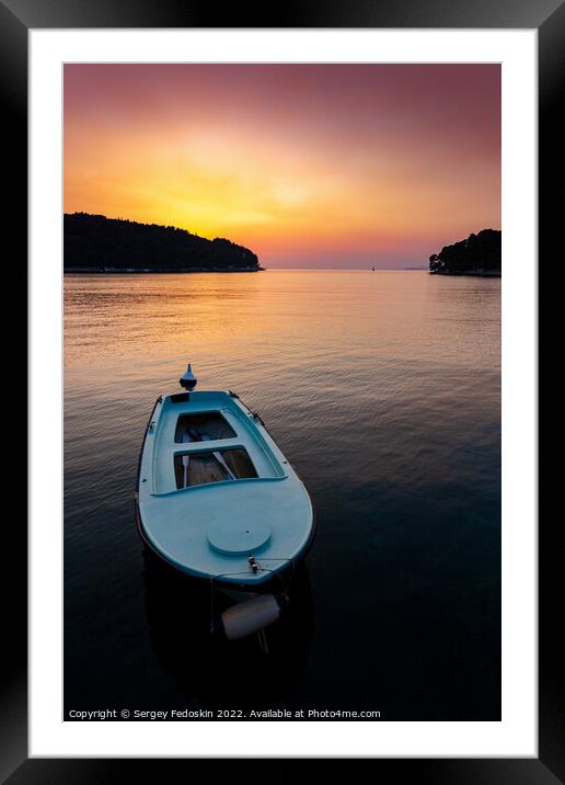 Fishing boats in a sea, near coast. Sunset time. Framed Mounted Print by Sergey Fedoskin