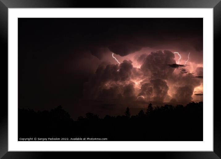 Lightning in the sky during a storm at night Framed Mounted Print by Sergey Fedoskin