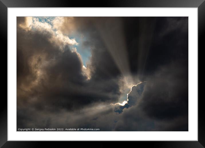 Dramatic storm clouds with sun rays. Framed Mounted Print by Sergey Fedoskin