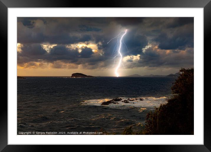 Dramatic dark stormy sky and lightning over a sea Framed Mounted Print by Sergey Fedoskin
