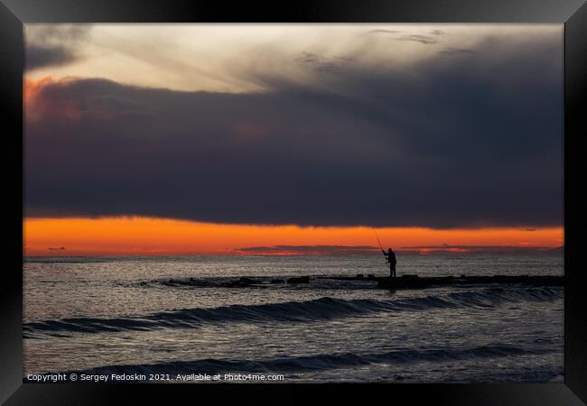 Fisherman on the sea at sunset. Framed Print by Sergey Fedoskin