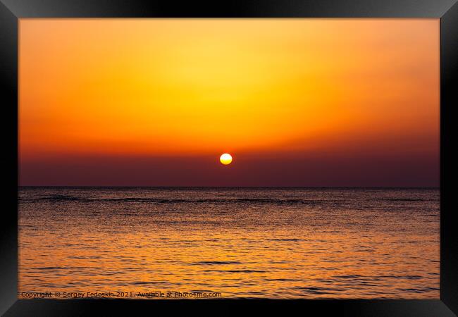 Bright sunset with a big yellow sun under the sea surface. Framed Print by Sergey Fedoskin