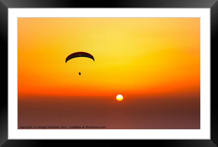 Paraglider flying in the beautiful sky against the background of Framed Mounted Print by Sergey Fedoskin