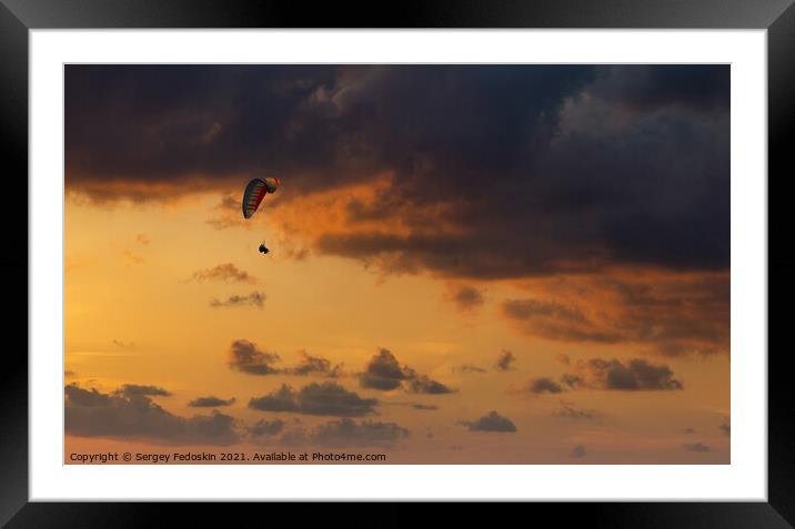 Paraglider flying in the beautiful sky against the background of Framed Mounted Print by Sergey Fedoskin