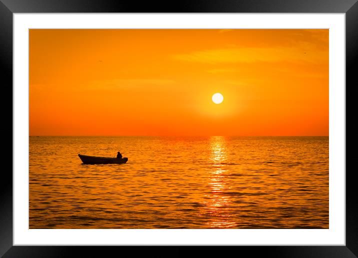 Sea sunset with a fishermans boat silhouette. Framed Mounted Print by Tartalja 