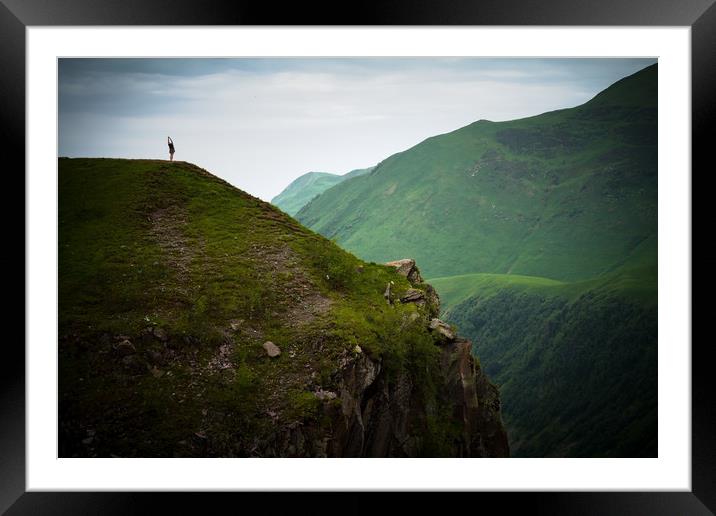 Yoga in the dark sombre mountains. Framed Mounted Print by Tartalja 