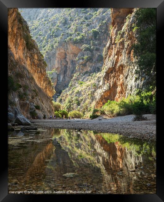 Tranquil Waters Beneath Mallorcan Peaks Framed Print by Bruce Little