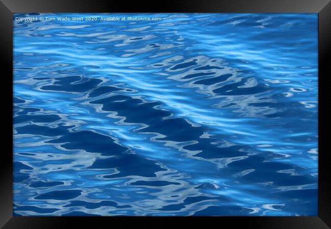 Ripples on a glassy sea. Framed Print by Tom Wade-West