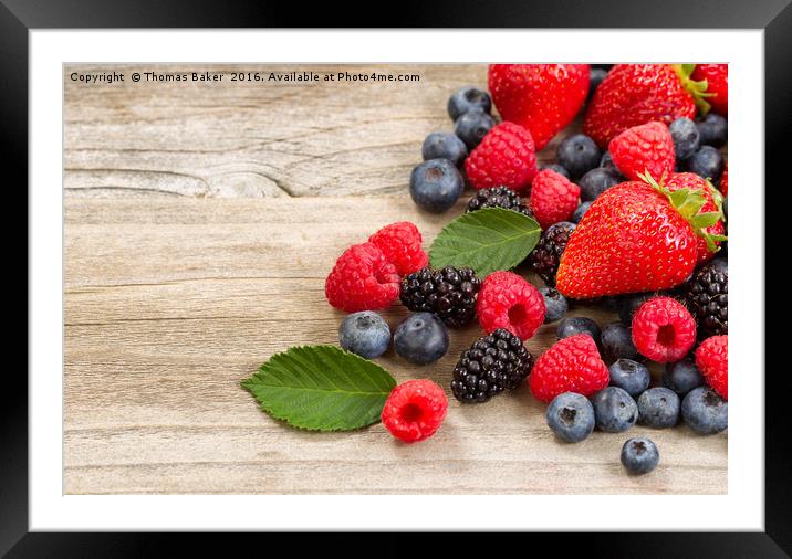 Freshly picked berries on rustic wooden boards Framed Mounted Print by Thomas Baker