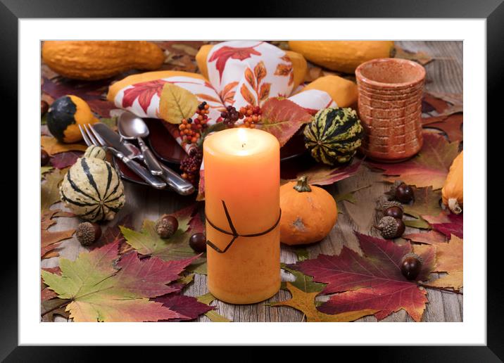 Holiday candle glowing for dinner setting for fall Framed Mounted Print by Thomas Baker