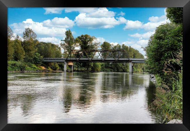 Railroad bridge over large flooded river  Framed Print by Thomas Baker