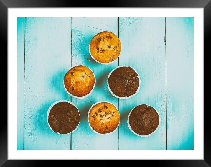 Homemade Chocolate Chip Muffins On Blue Table Framed Mounted Print by Radu Bercan