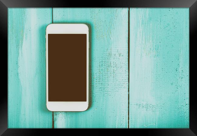 White Mobile Phone With Blank Screen On Wood Table Framed Print by Radu Bercan