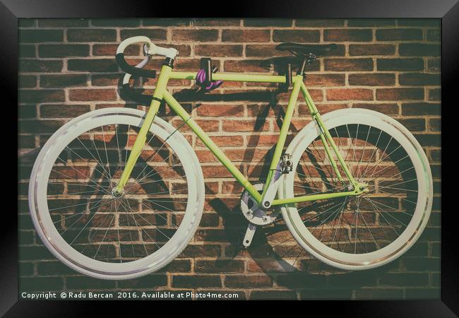 Bike Hanged On Brick Wall Framed Print by Radu Bercan