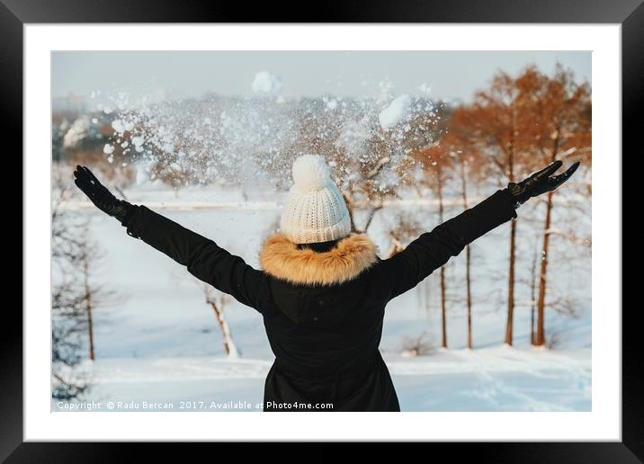 Happy Girl Throwing Snow In Air During Winter Framed Mounted Print by Radu Bercan