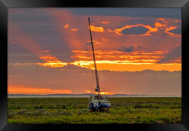 A sunset over a body of water Framed Print by Kevin Elias