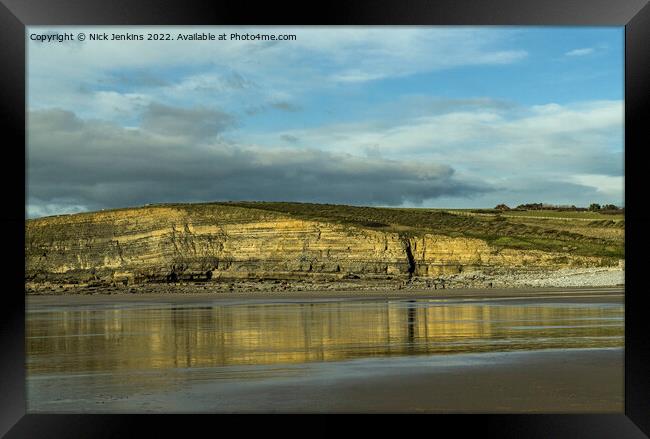 Dunraven Bay cliffs reflected in wet sand Framed Print by Nick Jenkins