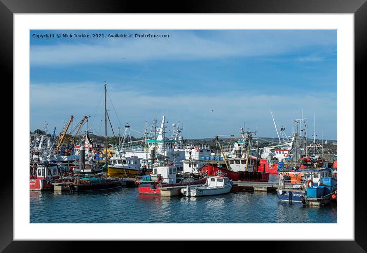 A Busy Newlyn Harbour with fishing boats moored up Framed Mounted Print by Nick Jenkins