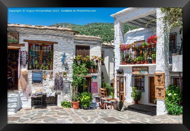 Souvenir shops in Pampaneira in Andalusia, Spain Framed Print by Angus McComiskey