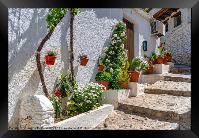 Colourful alleyway in Pampaneira, Andalusia, Spain Framed Print by Angus McComiskey