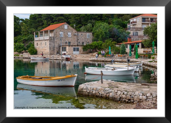 Boats tied up in Pomena harbour, Croatia Framed Mounted Print by Angus McComiskey