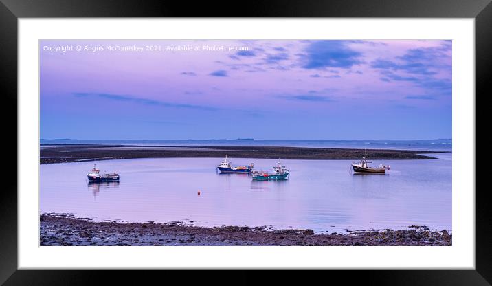 Fishing boats anchored at low tide, Holy Island Framed Mounted Print by Angus McComiskey