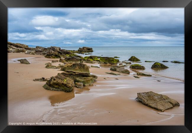 Rocks on Dornoch beach in Sutherland, Scotland Framed Print by Angus McComiskey