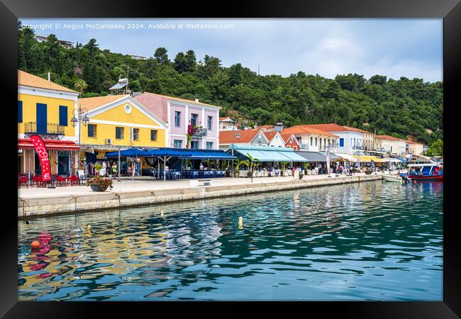 Colourful waterfront buildings at Katakolon Greece Framed Print by Angus McComiskey