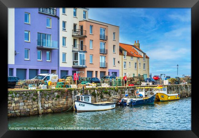 Colourful quayside buildings on St Andrews harbour Framed Print by Angus McComiskey