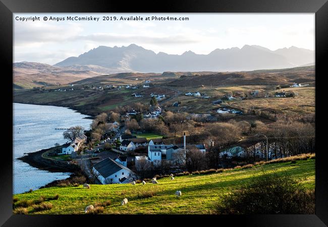 Looking over Carbost to the distant Cuillin Hills Framed Print by Angus McComiskey