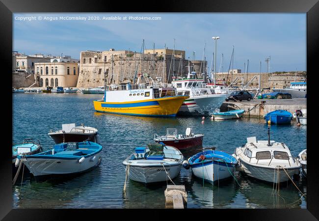 Boats tied up in Gallipoli harbour in Puglia Framed Print by Angus McComiskey