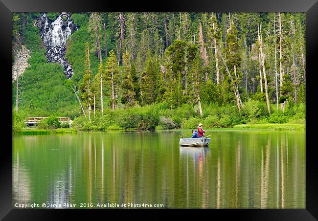 Two people fishing on a lake Framed Print by Jamie Pham