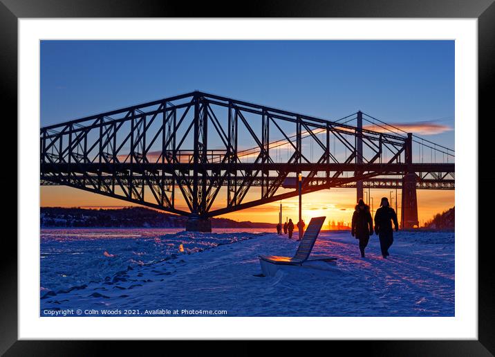 People walking by the frozen St Lawrence river in Quebec Canada Framed Mounted Print by Colin Woods