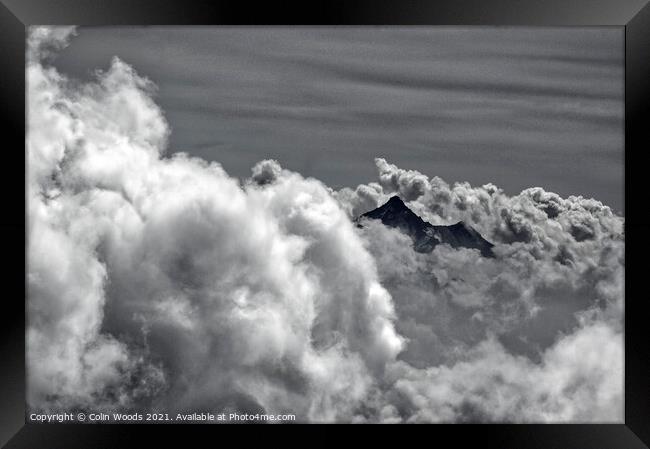 An alpine peak emerges from the clouds Framed Print by Colin Woods