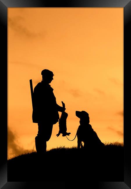 Hunter with Dog at Sunset Framed Print by Arterra 