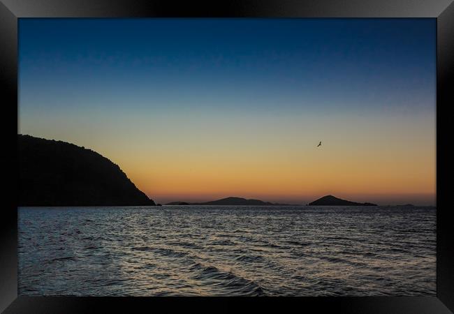 The sun rises over the Greek island of Patmos Framed Print by George Cairns