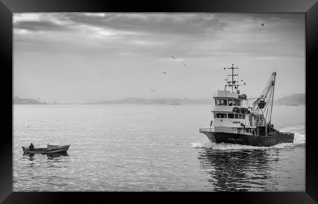 A fishing trawler sales on the river Bosphorus in  Framed Print by George Cairns