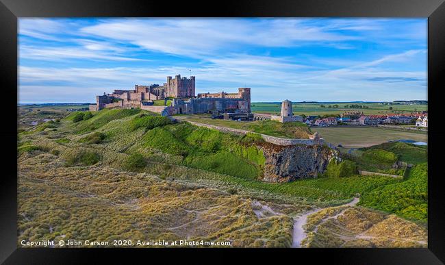 Majestic Bamburgh Castle at Sunrise Framed Print by John Carson