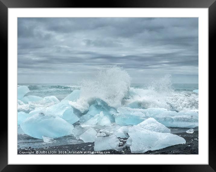 Waves breaking over blocks of ice Framed Mounted Print by JUDI LION